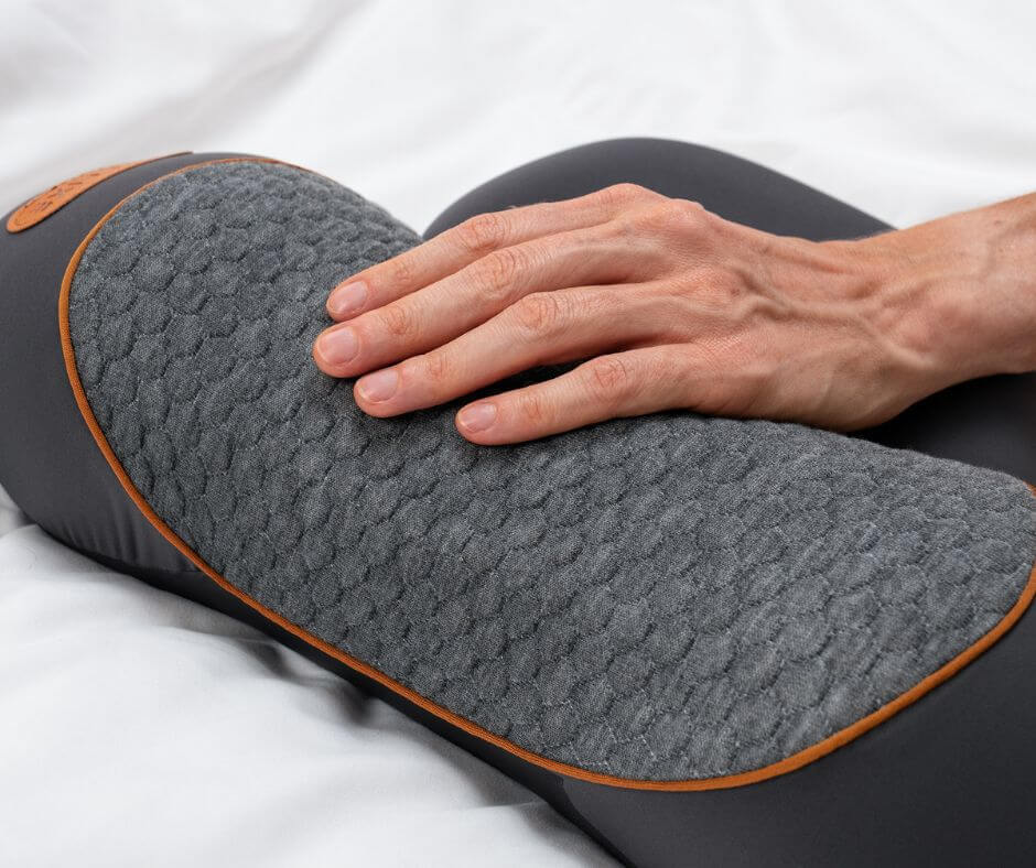 Close-up of Thera Pillow textured cushion with a hand on the surface