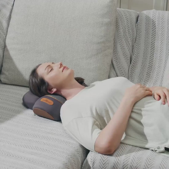 Woman using Thera Pillow for cervical traction with neck support