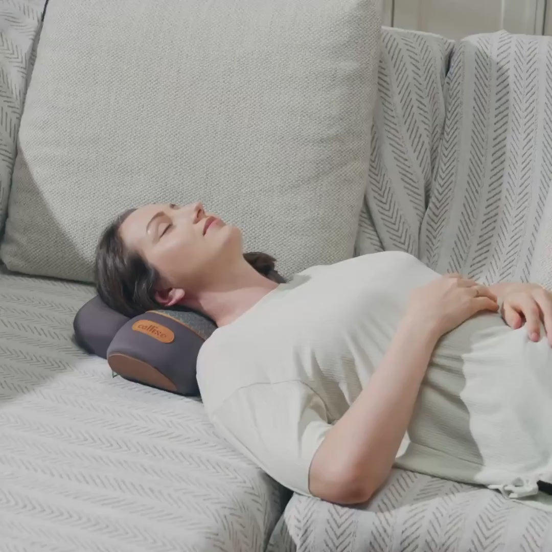 Woman using Thera Pillow for cervical traction with neck support